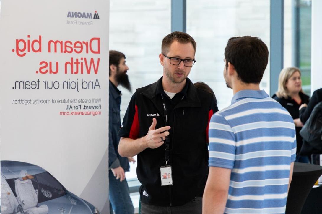 A student speaks with a prospective employer at a job fair